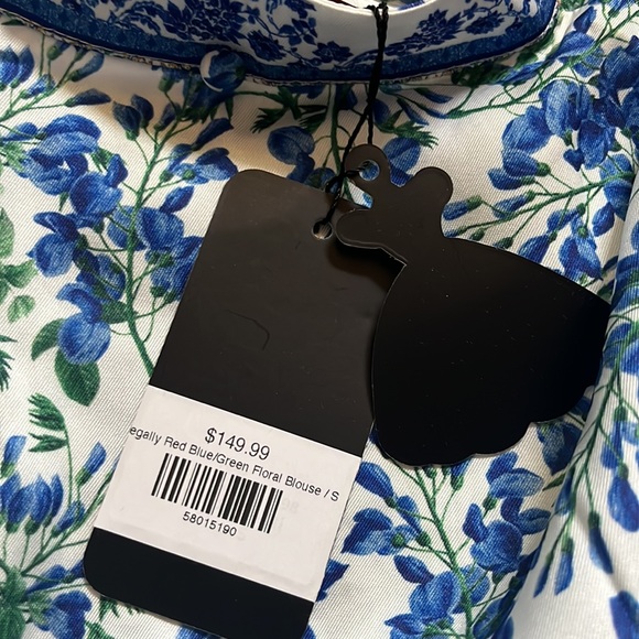 Stunning blue and white floral blouse. Blouse has a neck tie detail. - Picture 3 of 3